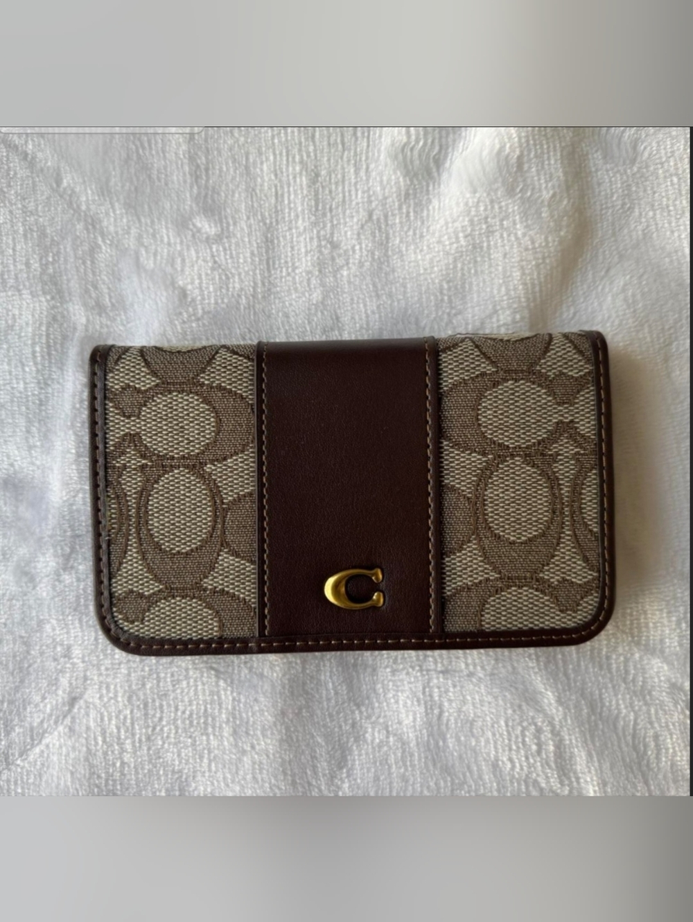 Brown  coin wallet with gold accents.